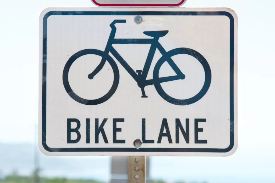 Close-up of 'bike lane' road sign with bike logo